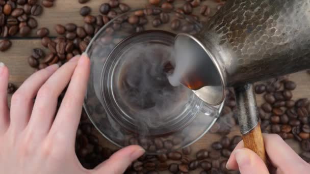 Kaffee mit Dampf aus einer Kaffeekanne in eine Tasse gegossen - Filmmaterial, Video