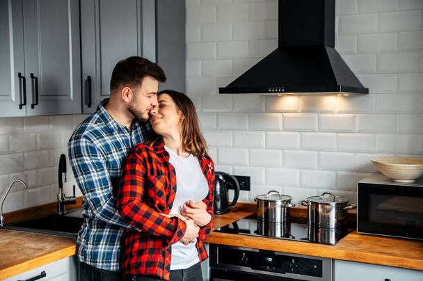 Young couple in love in the kitchen - Foto, imagen