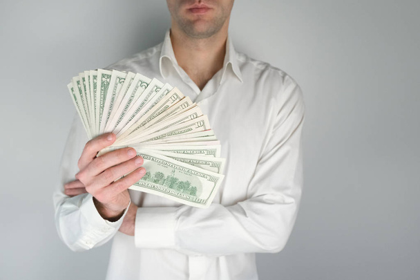 Man holds a lot of money. Concept of wealth, rich living, earning money online. - Φωτογραφία, εικόνα