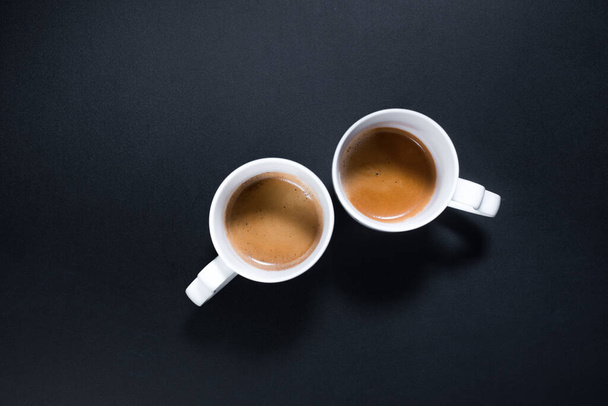 Fresh cups espresso coffee with milkon black background. Top view. Flat lay. Food minimalism concept - Foto, Imagen