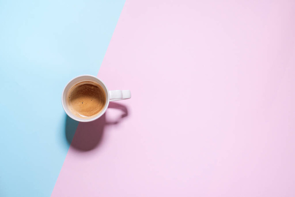 Fresh one cup espresso coffee with milk on pastel blue pink abstract color table. Food background. Top view. Flat lay. Minimalism - 写真・画像