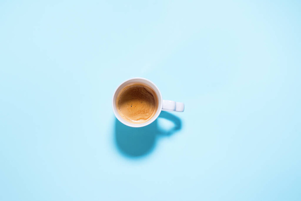Fresh one cup cappuccino coffee with milk on pastel blue color. Food background. Top view. Flat lay. Minimalism - Fotó, kép