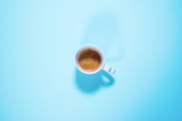 Fresh one cup cappuccino coffee with milk on pastel blue color. Food background. Top view. Flat lay. Minimalism - Фото, зображення