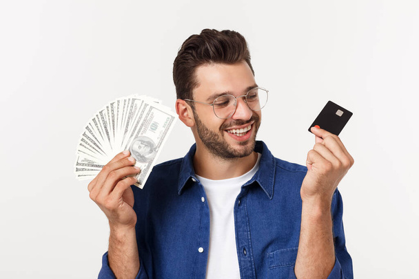 Portrait of a frinedly bearded man holding credit card and showing cash isolated over white background - Photo, image