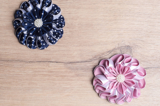 DIY flower from ribbon on wooden background.Copy space - Photo, Image