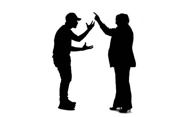 Silhouette of anonymous people on a white background fighting and being rude.  They are expressing anger with violence and confronting in an aggressive manner - Фото, изображение