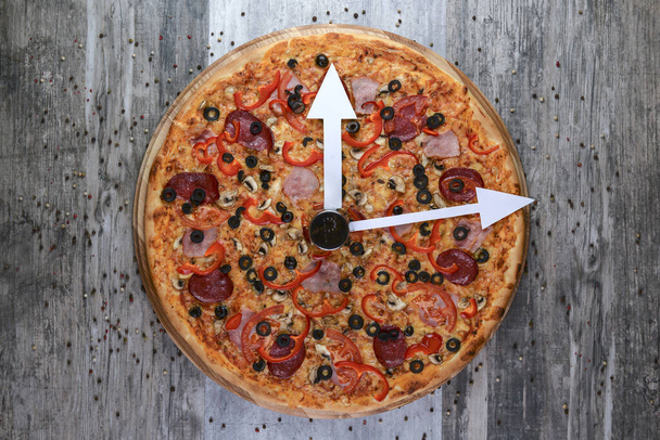 Flat lay photograph of tasty italian pizza on rustic wood. Pepperoni, cheese and peppers. Delicious food. - 写真・画像