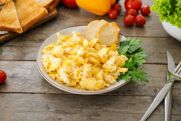 Plate with scrambled egg on table - Photo, Image