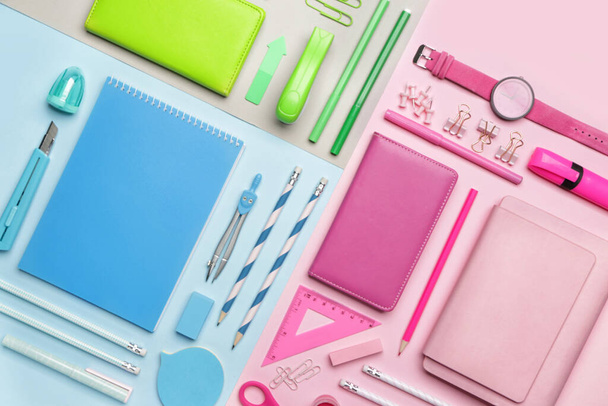Set of school supplies with clock on color background - Foto, afbeelding