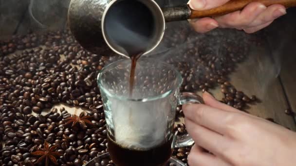Coffee with steam poured from a coffee pot into a cup - Footage, Video