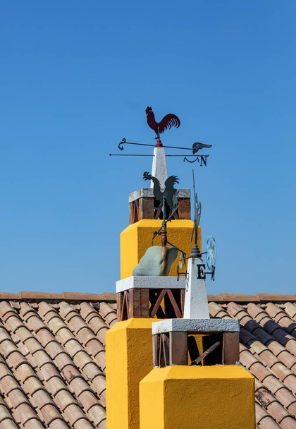 Yellow chimneys decorated with artistic metalwork at Strada del Prosecco, Italy - Photo, Image