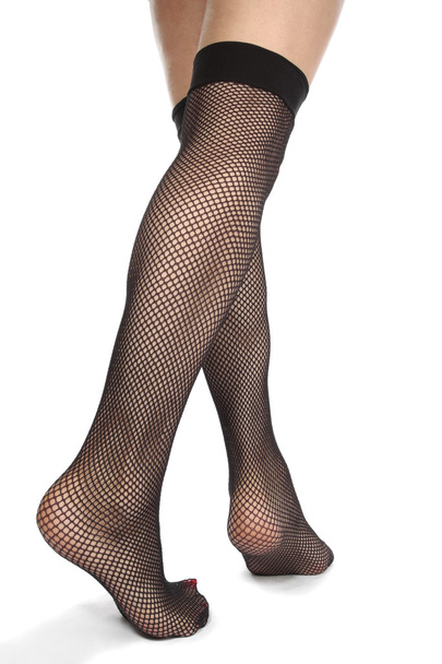Woman feet with fishnet tights isolated over white background - Zdjęcie, obraz