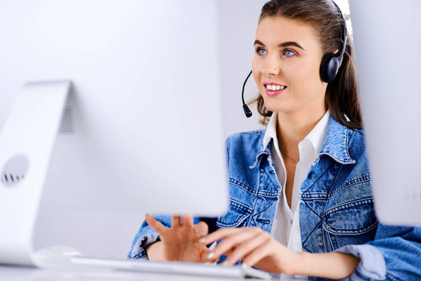 Giovane call center agente femminile navigando in Internet sul suo computer
 - Foto, immagini
