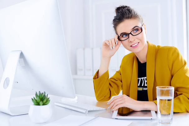 Attractive business woman with glasses working in office - Photo, Image