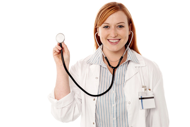 Female physician posing with stethoscope - 写真・画像
