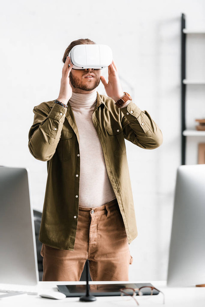 3d artist using vr headset while working near computers and graphics tablet on table in office  - Photo, Image