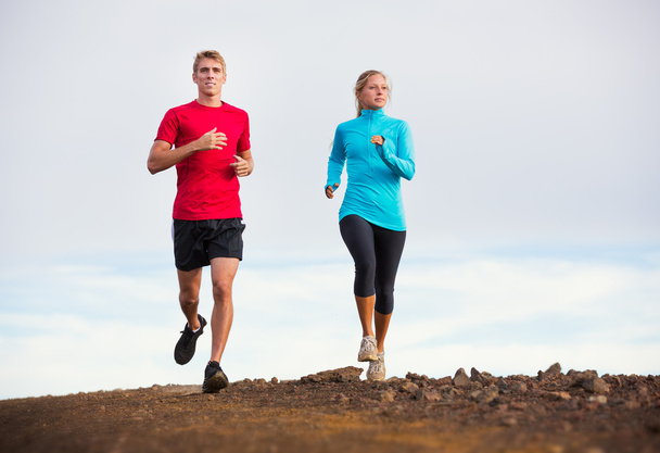 Fitness sport couple running jogging outside on trail - Photo, image