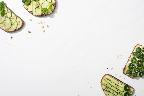top view of fresh cucumber toasts on white background - Fotoğraf, Görsel