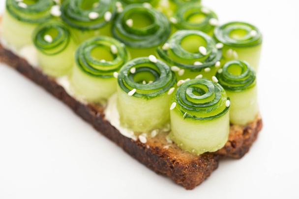 close up view of fresh cucumber toast with sesame on white background - Photo, Image