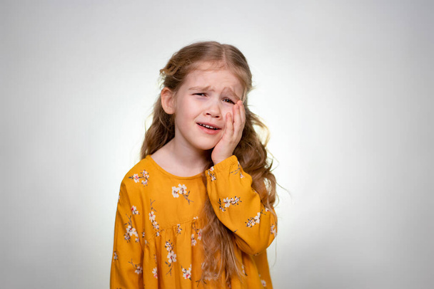 Strong Toothache little girl with long blonde hair - Foto, imagen