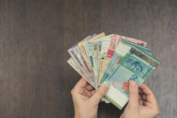 woman holding various money bills - Foto, Imagem