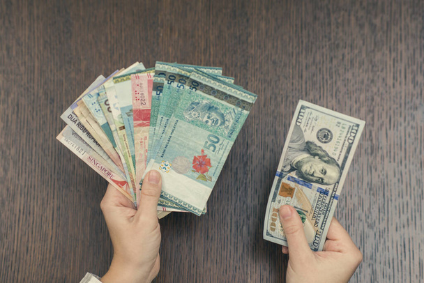 woman holding various money bills - Фото, зображення