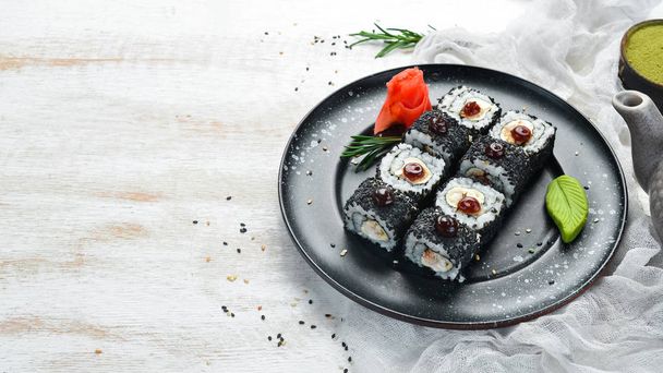 Set of sushi with eel fish and black sesame. Sushi menus. Top view. Free space for your text. - Фото, изображение