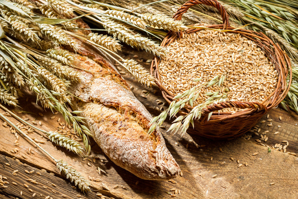 Fresh baguette with cereal grains in a basket - Foto, afbeelding