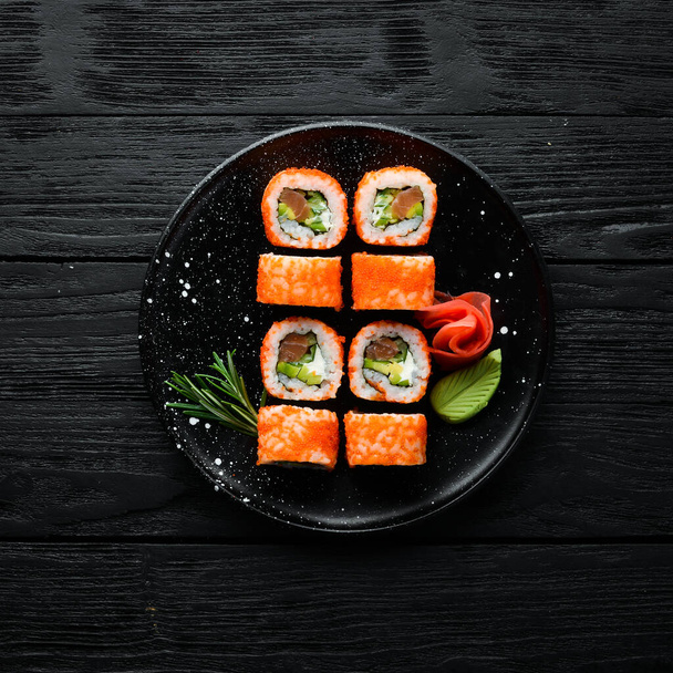 Sushi set with caviar, avocado and salmon. Asian cuisine. Top view. Free space for your text. - Zdjęcie, obraz