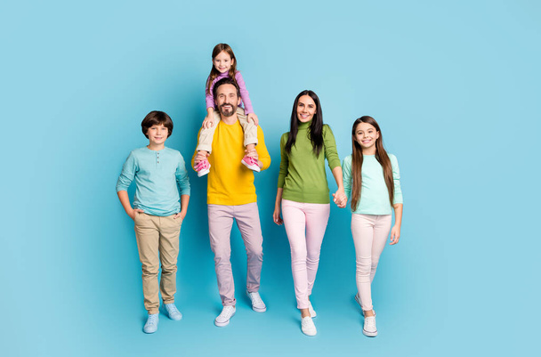 Full length body size view of nice attractive lovely adorable glad friendly cheerful family walking holding hands spending day daydream isolated on bright vivid shine vibrant blue color background - Photo, image