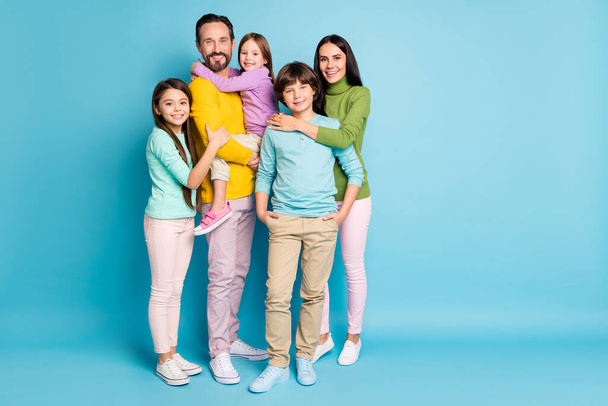 Full length body size view of nice attractive lovely adorable tender sweet gentle cheerful cheery family teenage hugging growing-up isolated on bright vivid shine vibrant blue color background - Fotoğraf, Görsel
