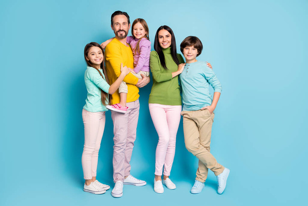 Full length body size view of nice attractive lovely perfect glad cheerful cheery family schoolkids mommy daddy offspring kids embracing isolated on bright vivid shine vibrant blue color background - Valokuva, kuva