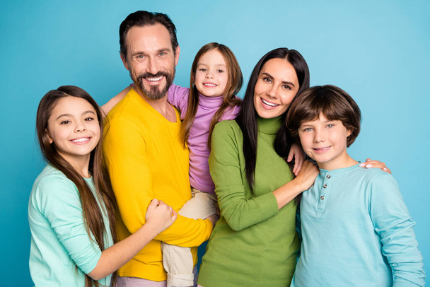 Close-up portrait of nice attractive lovely perfect tender sweet glad cheerful cheery family schoolkids mom dad embracing spending day isolated on bright vivid shine vibrant blue color background - Foto, Bild