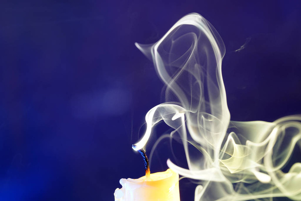 Candle with smoke and flame photographed in the studio with color foils before the flashes                      - Photo, Image