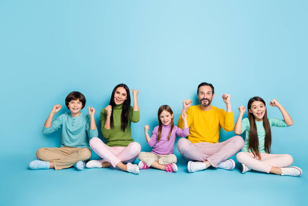 Nice attractive lovely cheerful cheery big full family schoolkids mom dad sitting in lotus pose enjoying celebrating luck isolated on bright vivid shine vibrant blue color background - Zdjęcie, obraz