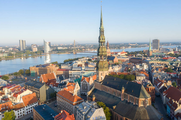 Aerial view photo from flying drone panoramic  to St. Peter's Church and the Old Town on the background of the Daugava River and downtown on a beautiful early morning sunrise (series) - Photo, Image