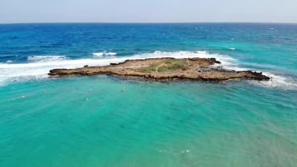 Drone kilátás kék azúrvíz tenger Cipruson, hullámok és sziget háttér - Felvétel, videó