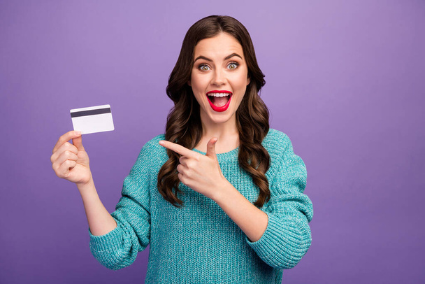 Photo of pretty manager lady presenting advising low prices shopping with new credit card wireless service direct finger wear blue pullover isolated purple color background - Fotografie, Obrázek
