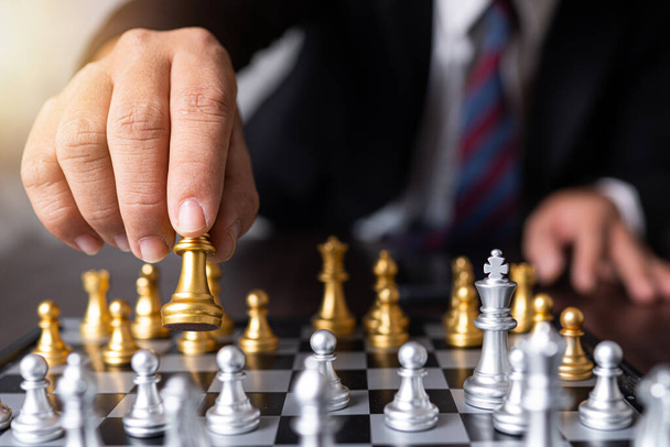 Planning and strategy of successful business competition management concept, businessman moves king of chess - Photo, Image