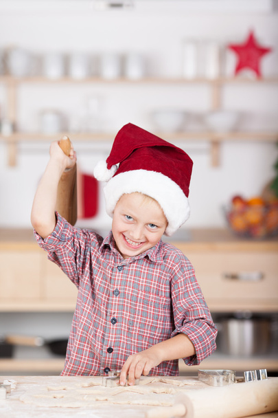 Laughing little boy baking Christmas cookies - 写真・画像