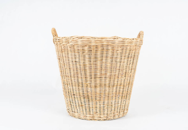 Wicker basket of clothes isolated on white background  - Photo, Image
