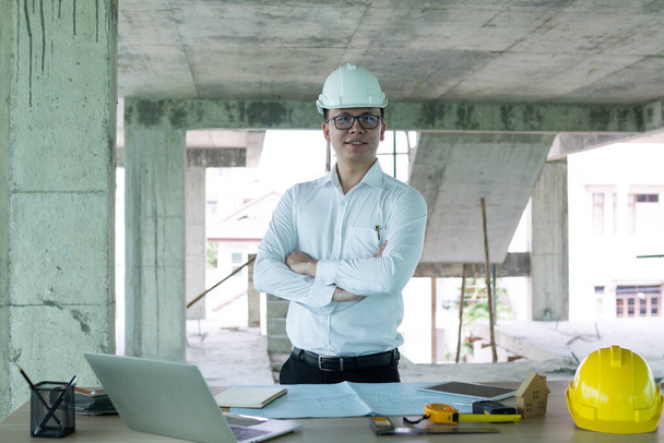 business, building, industry, technology and people concept, Portrait of young engineer in construction site, engineering technology concept - Photo, Image