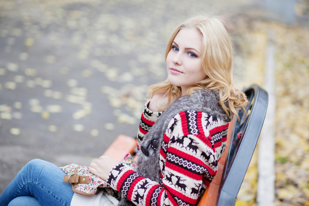 Young blonde girl in cardigan with a traditional Celtic ornament - Foto, afbeelding