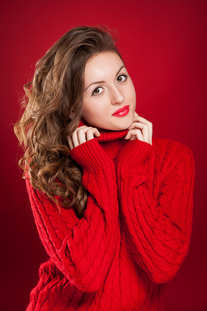 beautiful brunette girl wearing red sweater - Photo, image