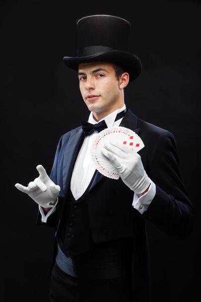 Magician showing trick with playing cards - Фото, изображение