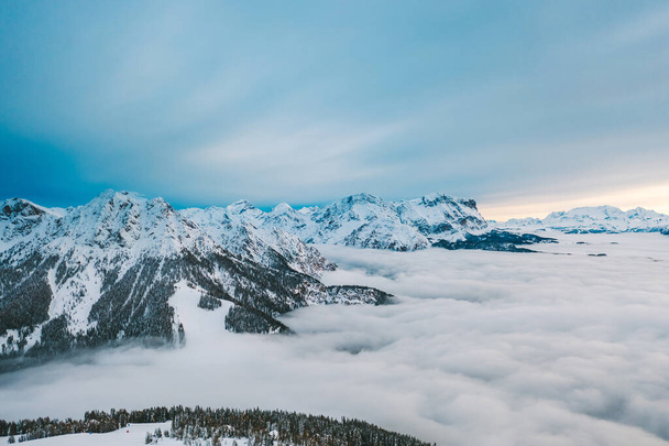 Drone aerial view of snowy mountains in Kronplatz, Italy. It is a mountain of the Dolomites in South Tyrol, with a summit elevation of 2,275 metres (7,464 ft) above sea level - Photo, Image