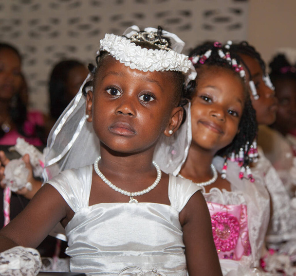 Portrait of a serious little girl in wedding dresses. Very cute kids in the Wedding Ceremony. Selective focus, children family happiness. - Photo, Image