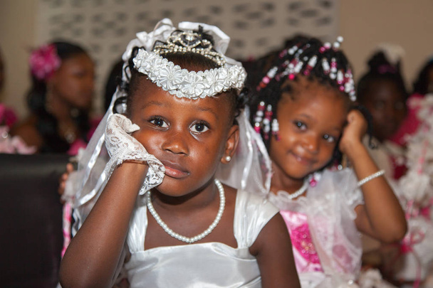 Portrait of pensive and cheerful little girls in wedding dresses. Selective focus. Very cute kids in the Wedding Ceremony, children family happiness. - Photo, Image