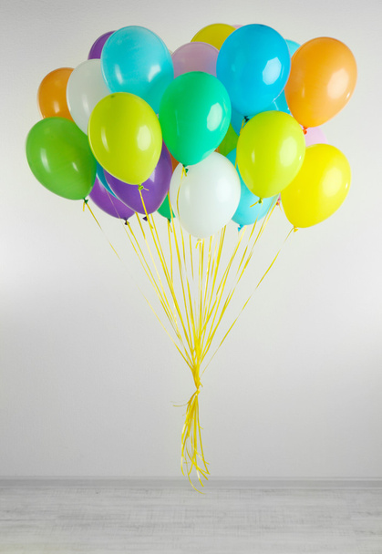 Colorful balloons on grey background - Фото, изображение