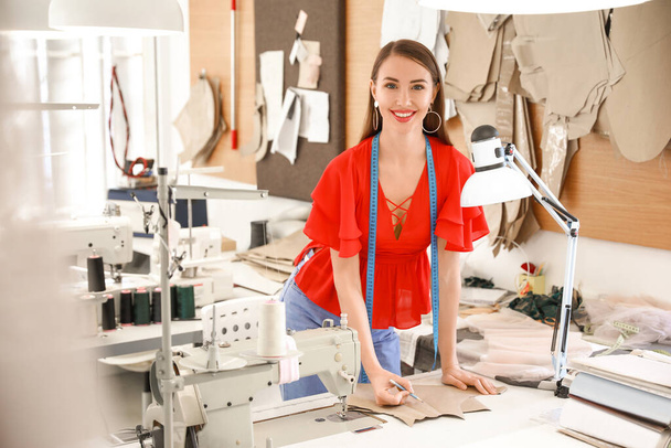 Female tailor working in modern atelier - Fotografie, Obrázek